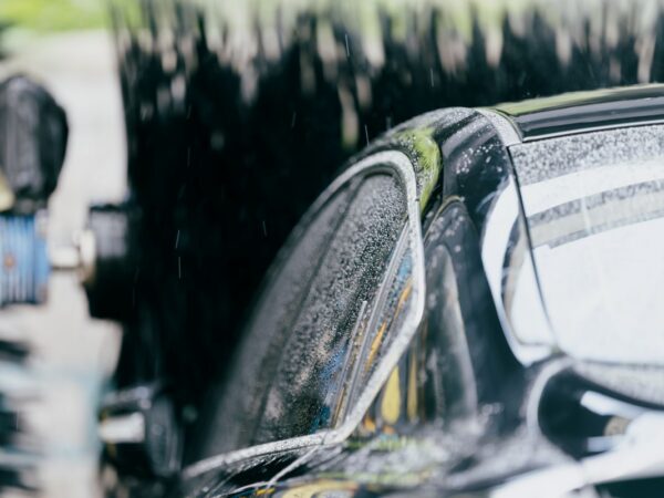 A closeup of a car going through a tunnel car wash